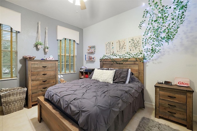 tiled bedroom featuring ceiling fan