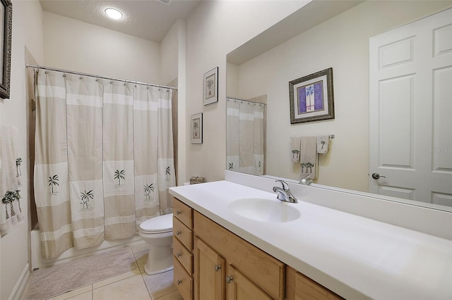 bathroom featuring tile patterned floors, toilet, vanity, and a textured ceiling