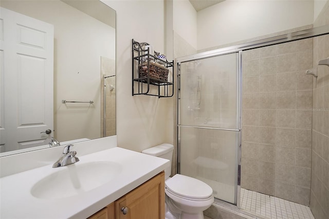 bathroom featuring vanity, toilet, and a shower with shower door