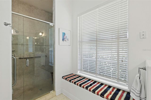 bathroom featuring a shower with shower door