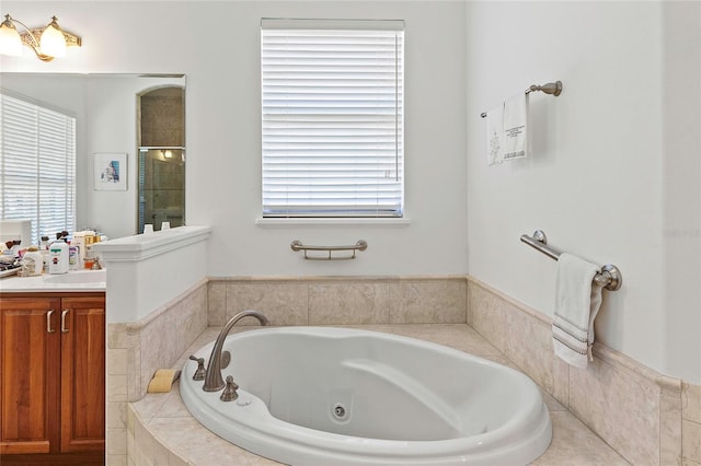 bathroom featuring separate shower and tub and vanity