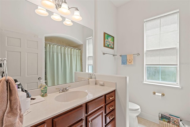 bathroom with a notable chandelier, toilet, and vanity