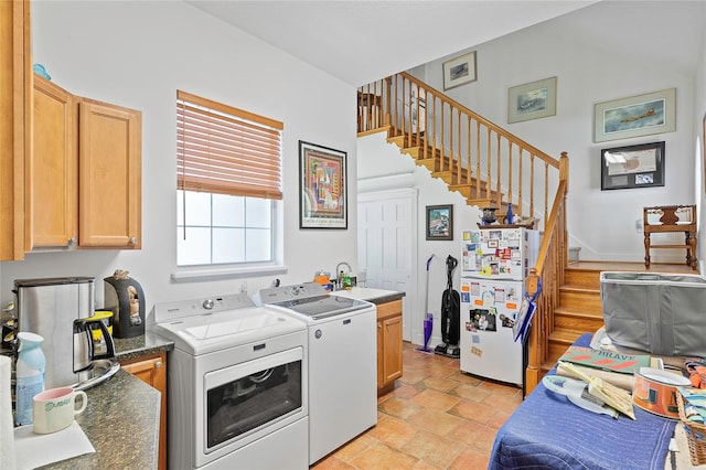 kitchen with light brown cabinets, independent washer and dryer, white fridge, sink, and light tile patterned flooring