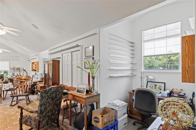 home office with a textured ceiling, ceiling fan, and lofted ceiling