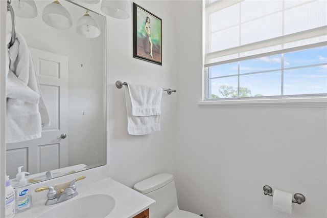 bathroom featuring toilet and vanity