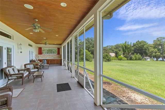 sunroom / solarium with wood ceiling and ceiling fan