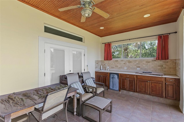 kitchen with wood ceiling, ceiling fan, light tile patterned flooring, and tasteful backsplash