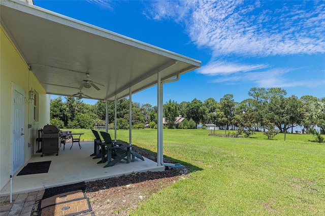 view of yard with ceiling fan and a patio