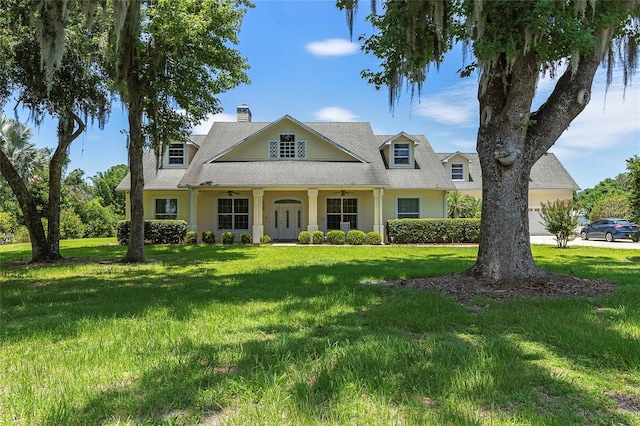 view of front of property featuring a garage and a front lawn