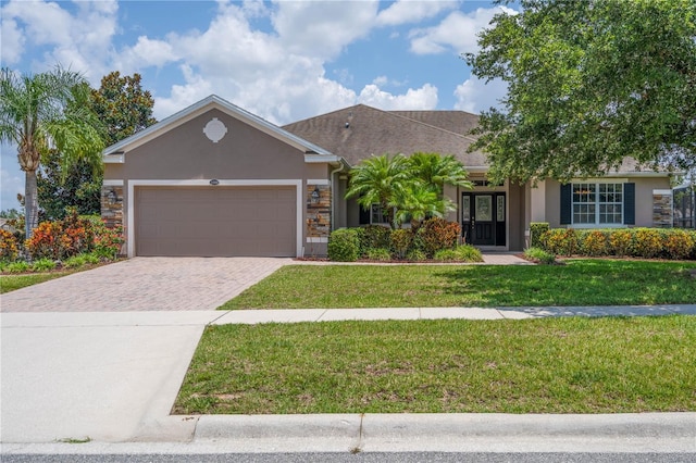 view of front facade with a garage and a front lawn