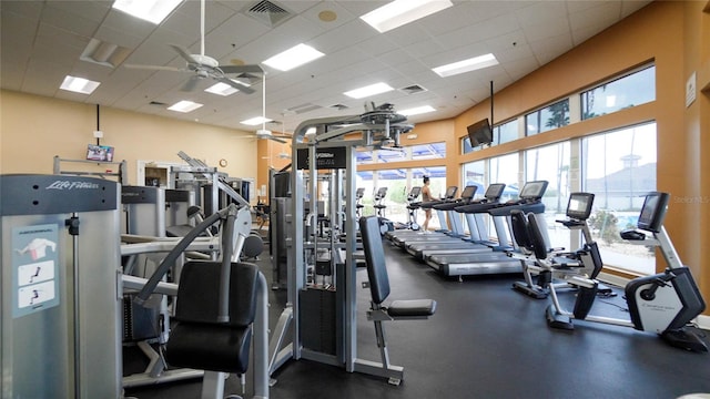 gym featuring ceiling fan and a paneled ceiling