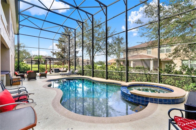 view of pool with a lanai, an in ground hot tub, and a patio