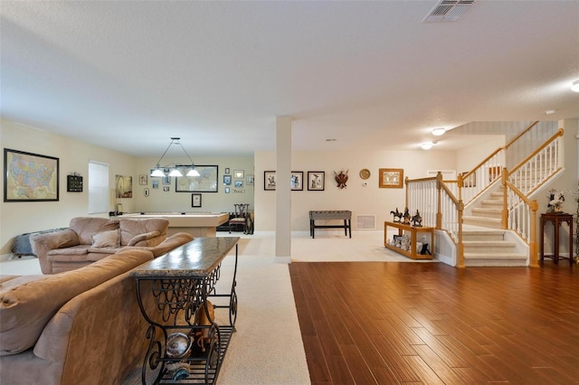 living room featuring a textured ceiling and wood-type flooring