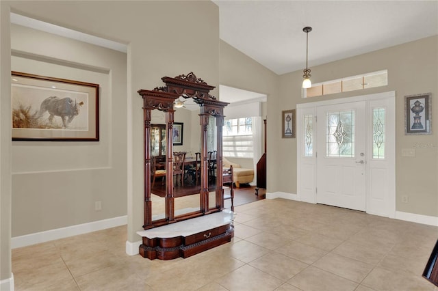 tiled foyer entrance featuring lofted ceiling