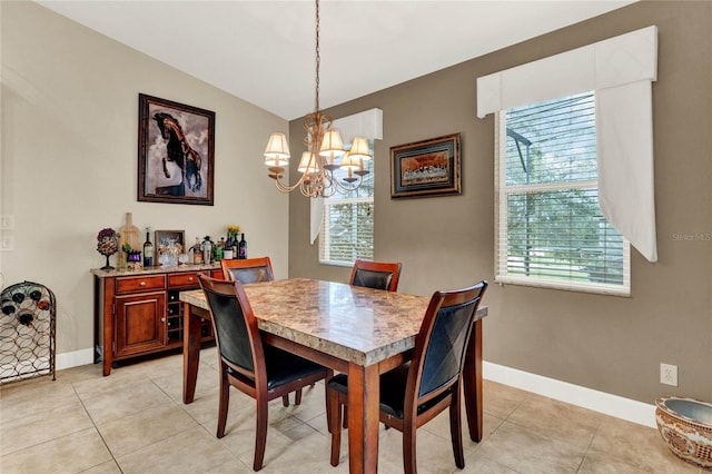 dining space with a chandelier and light tile patterned flooring