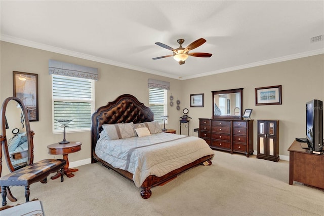 carpeted bedroom featuring ceiling fan and crown molding