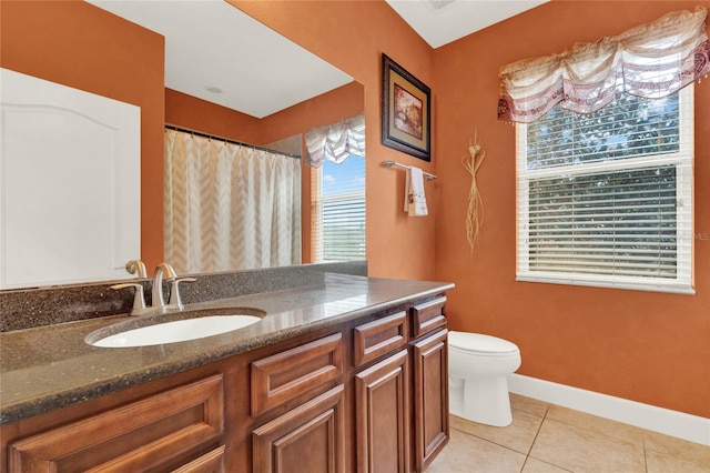 bathroom featuring toilet, vanity, and tile patterned flooring