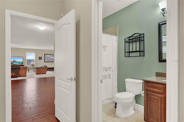 bathroom featuring hardwood / wood-style flooring, a textured ceiling, toilet, and vanity