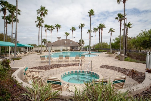 view of swimming pool featuring a patio area and a community hot tub