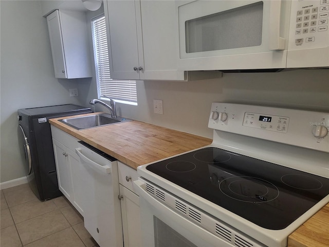 kitchen featuring sink, a healthy amount of sunlight, white appliances, and white cabinetry