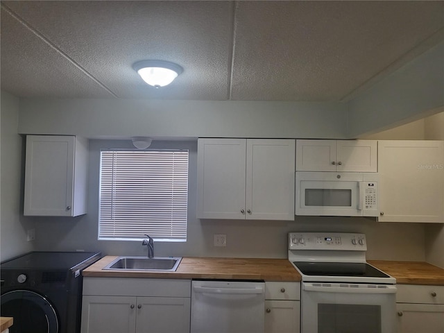 kitchen featuring white cabinets, butcher block countertops, sink, and white appliances