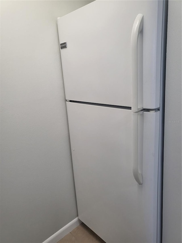 room details with tile flooring and white fridge