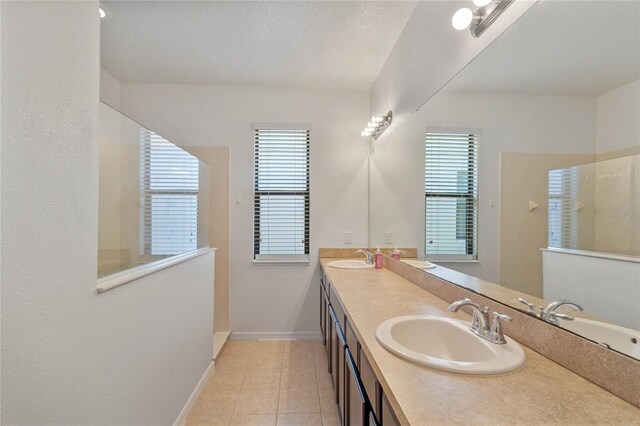 bathroom featuring tile patterned floors, vanity, and tiled shower