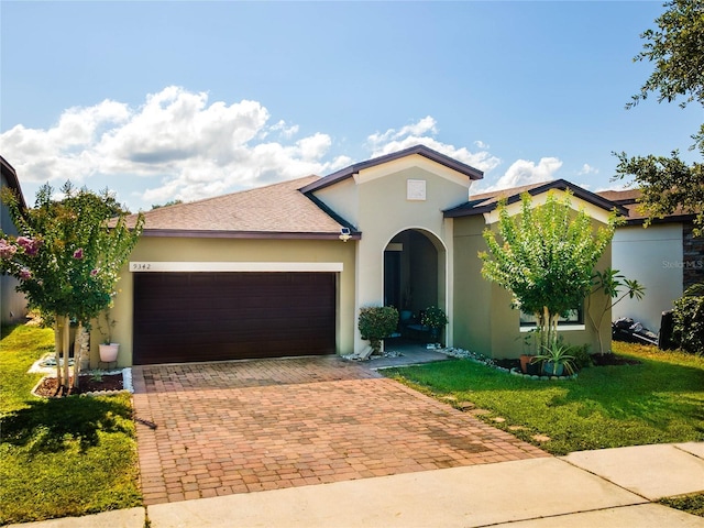 view of front of home with a garage and a front lawn