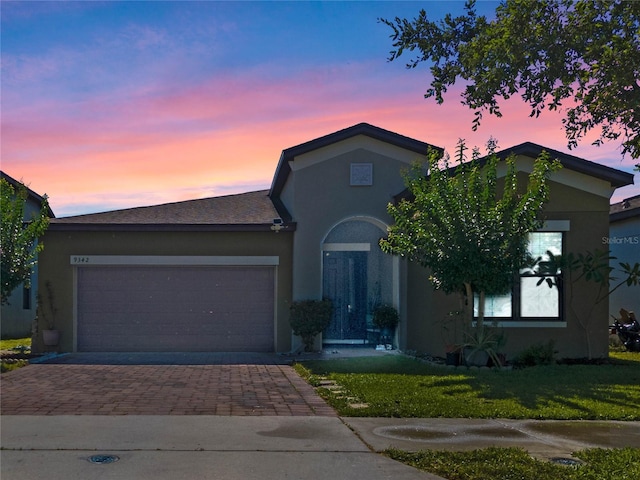 view of front facade with a lawn and a garage