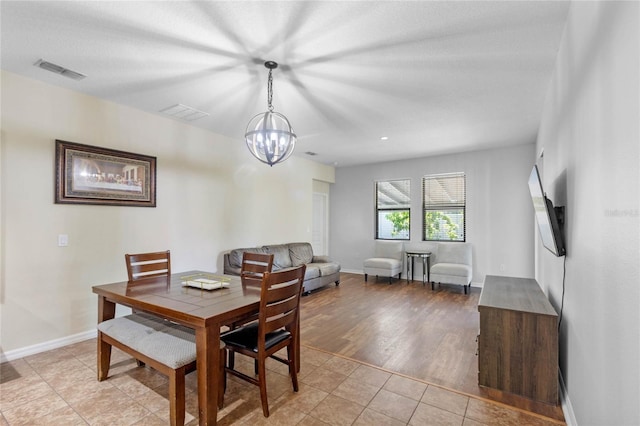 dining room featuring light tile patterned floors and a chandelier