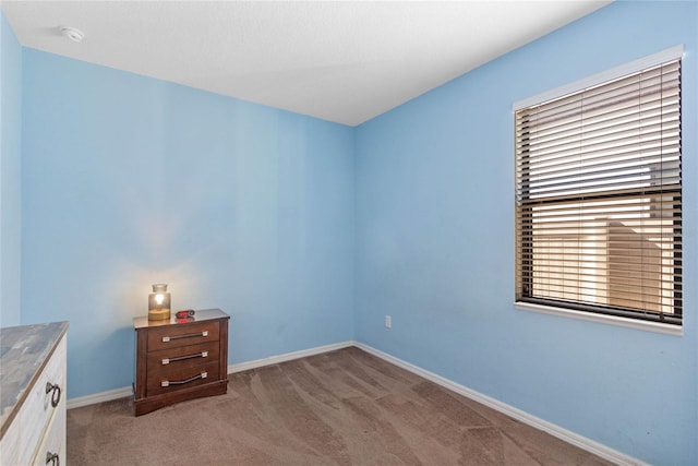 unfurnished room featuring light carpet