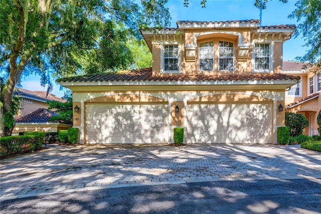 mediterranean / spanish house featuring a garage