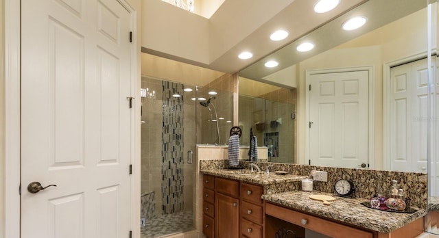 bathroom with vanity and a shower with door