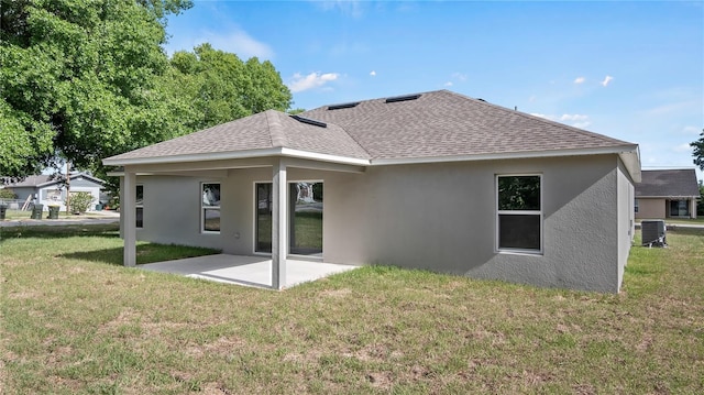 rear view of house with a yard, central AC unit, and a patio area