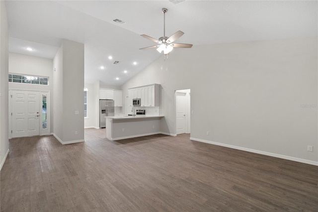 unfurnished living room featuring ceiling fan, dark hardwood / wood-style flooring, and high vaulted ceiling