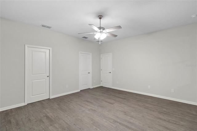 unfurnished room featuring ceiling fan and dark hardwood / wood-style flooring