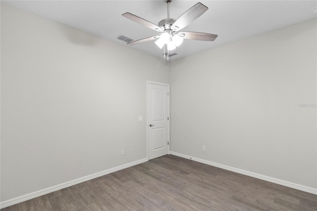 empty room featuring ceiling fan and dark hardwood / wood-style flooring