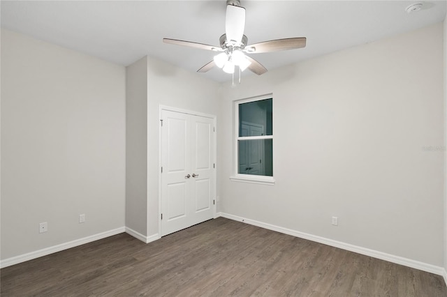 spare room featuring dark hardwood / wood-style floors and ceiling fan