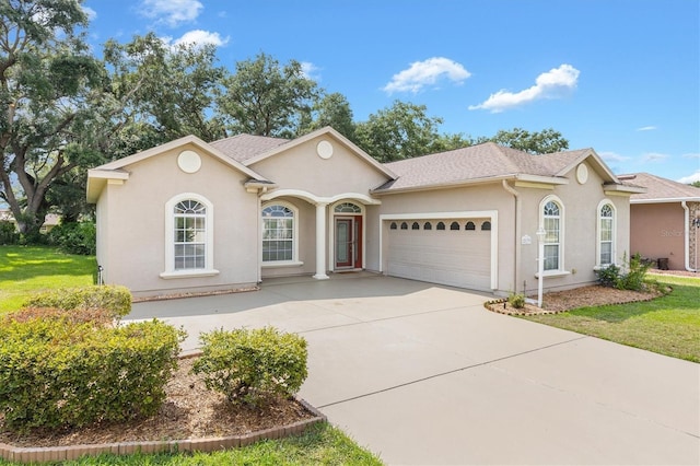 view of front of house with a front yard and a garage