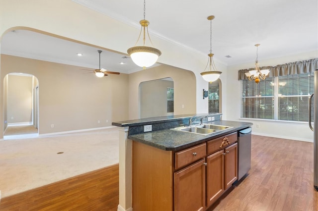 kitchen featuring dishwasher, pendant lighting, an island with sink, ceiling fan with notable chandelier, and sink