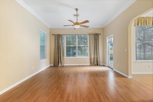 empty room with ceiling fan, crown molding, and light hardwood / wood-style flooring