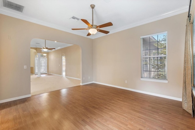 empty room featuring ceiling fan, crown molding, and hardwood / wood-style flooring