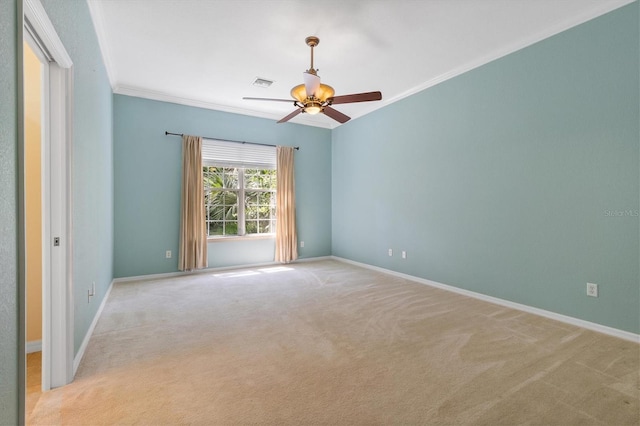 spare room with ornamental molding, ceiling fan, and light carpet