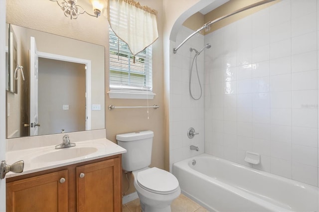 full bathroom featuring toilet, tiled shower / bath combo, tile patterned floors, and vanity