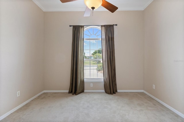 unfurnished room featuring light colored carpet, ceiling fan, and crown molding