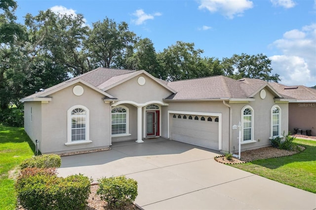 ranch-style home featuring a front yard and a garage