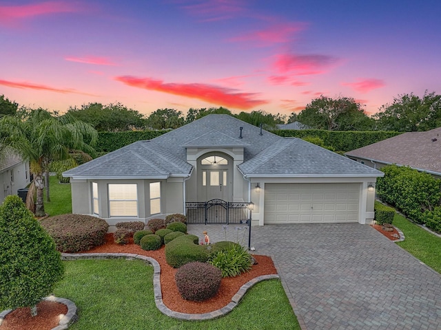 view of front of property featuring a yard and a garage