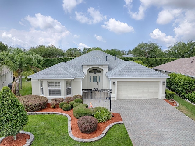 view of front facade with a garage and a front yard