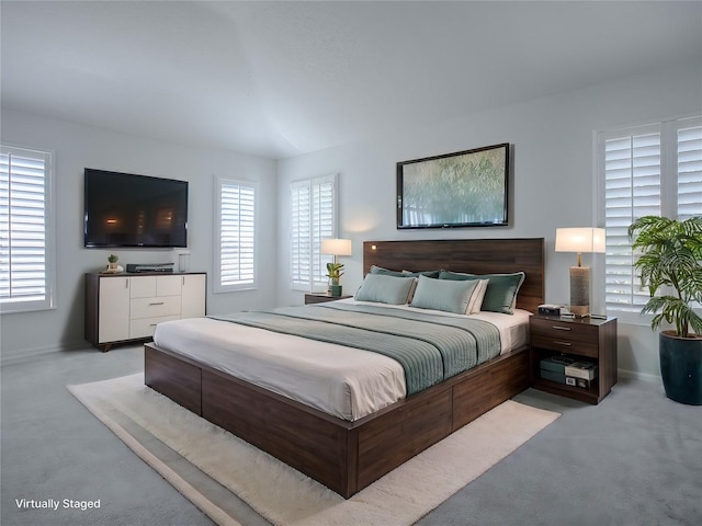 carpeted bedroom featuring multiple windows