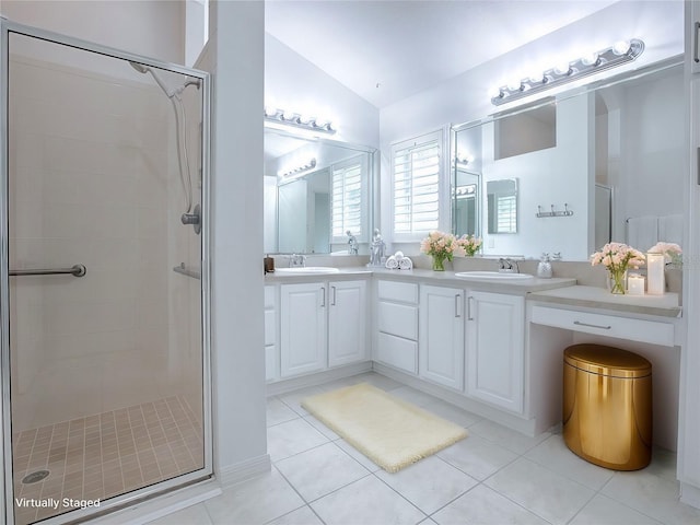 bathroom featuring tile patterned flooring, vanity, a shower with shower door, and vaulted ceiling